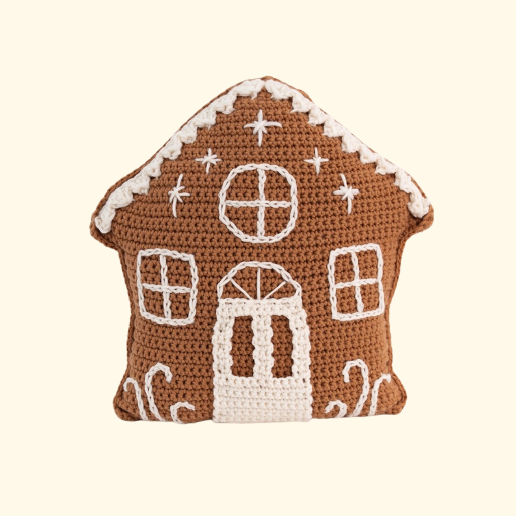 Completed gingerbread house cushion made with the Wool Couture Gingerbread House Cushion Crochet Kit.