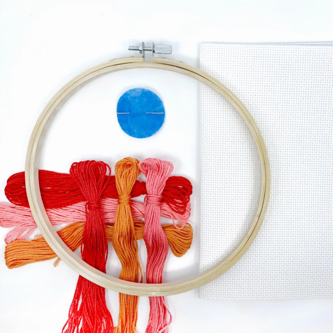 Harvest Grid cross stitch in an embroidery hoop showing stitching in progress with colourful embroidery floss.