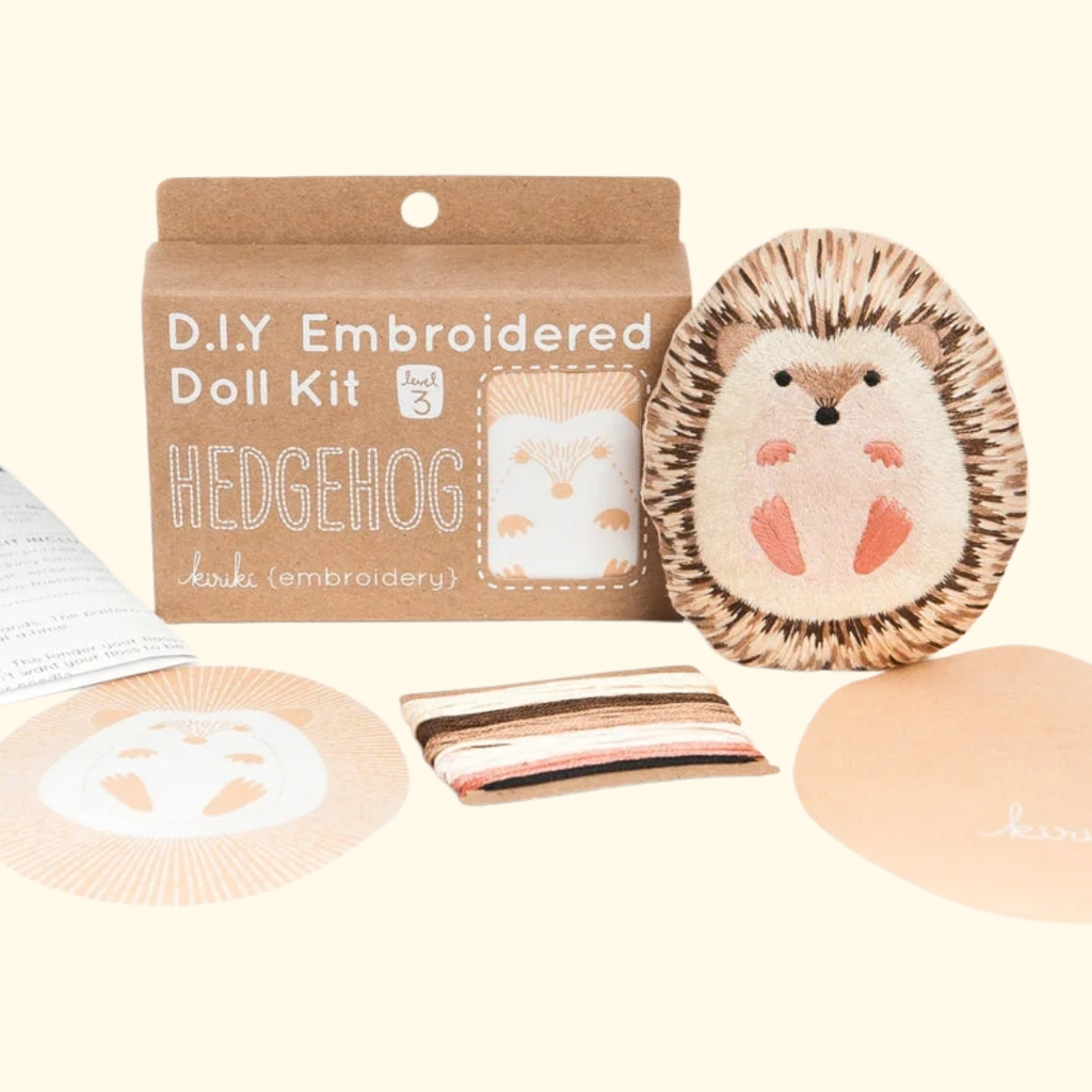 Kiriki Press Hedgehog Embroidery Kit with embroidery hoop, thread, printed fabric, instructions and finished hedgehog doll.