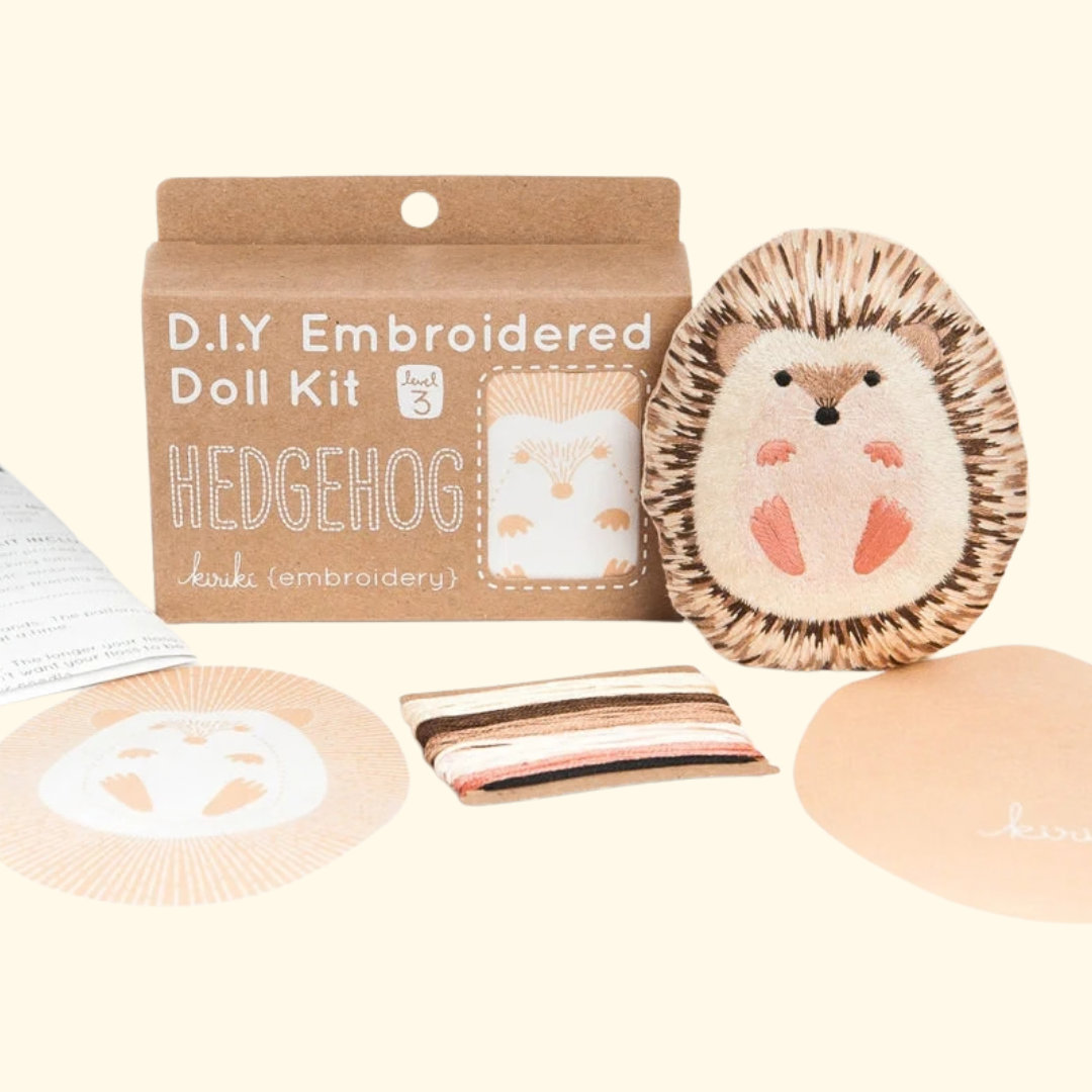 Kiriki Press Hedgehog Embroidery Kit with embroidery hoop, thread, printed fabric, instructions and finished hedgehog doll.