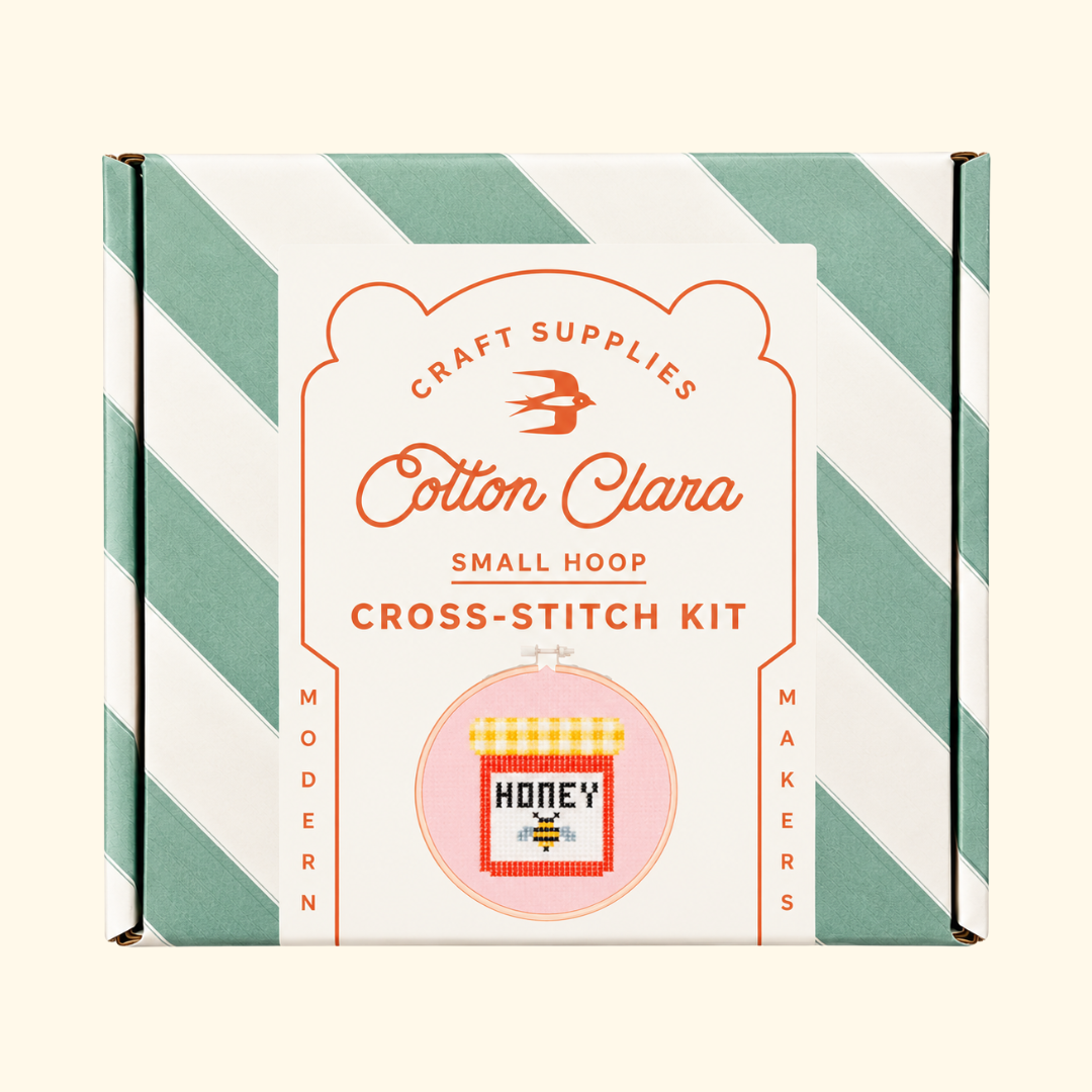 Cotton Clara Honey Jar Cross Stitch Kit in its mint green and white striped presentation box.