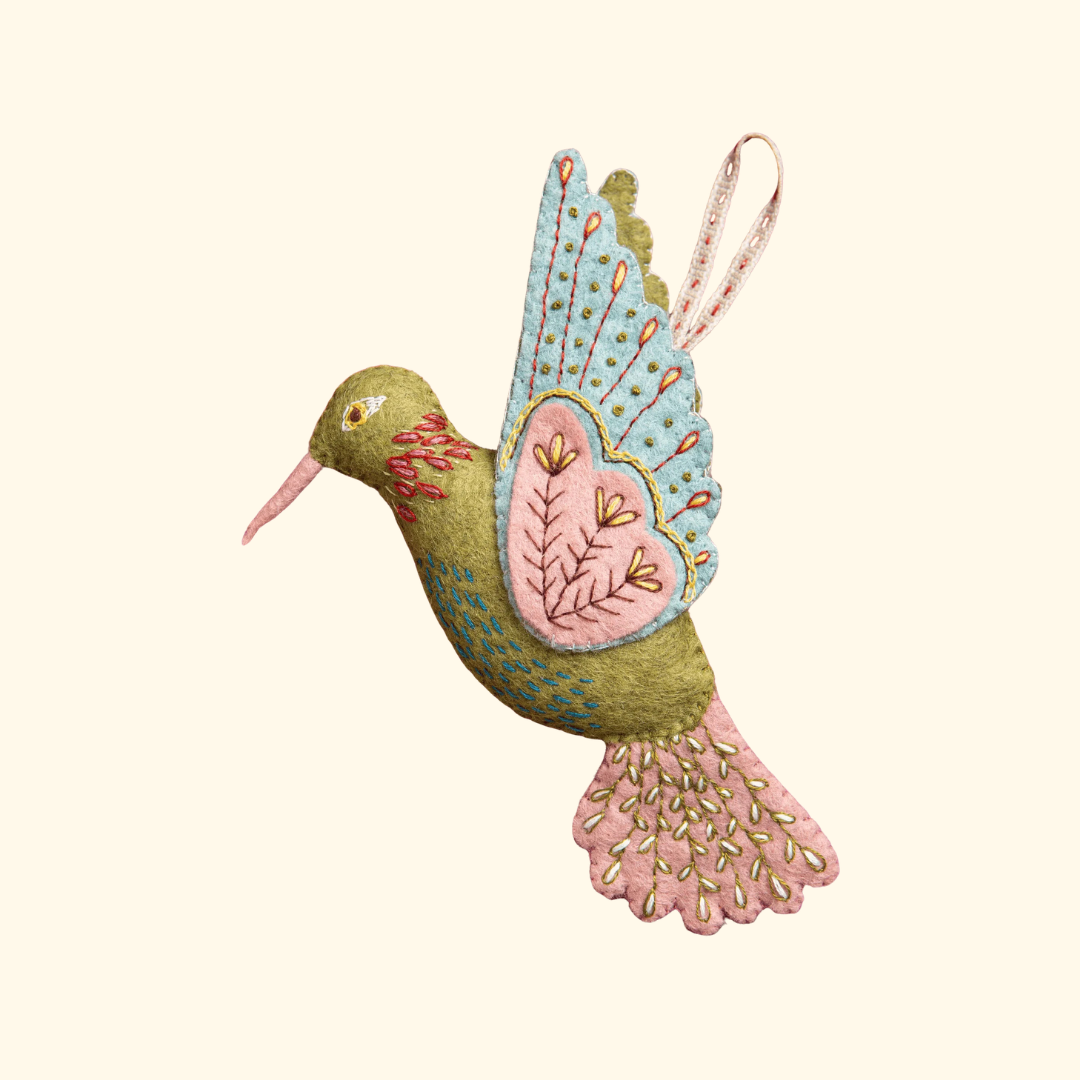 Completed hummingbird ornament from the Hummingbird Felt Craft Kit by Corinne Lapierre featuring embroidered details and pastel felt applique.