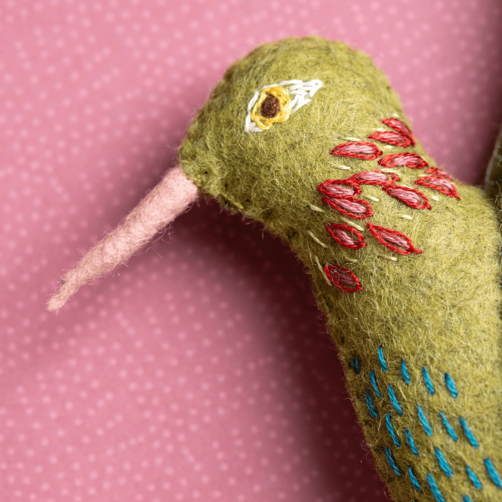 Close up of the hummingbird head showing embroidered details and hand stitched felt elements from the Hummingbird Felt Craft Kit by Corinne Lapierre.