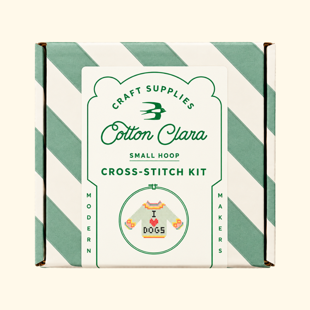 Cotton Clara I Love Dogs Cross Stitch Kit in its mint green and white striped presentation box.