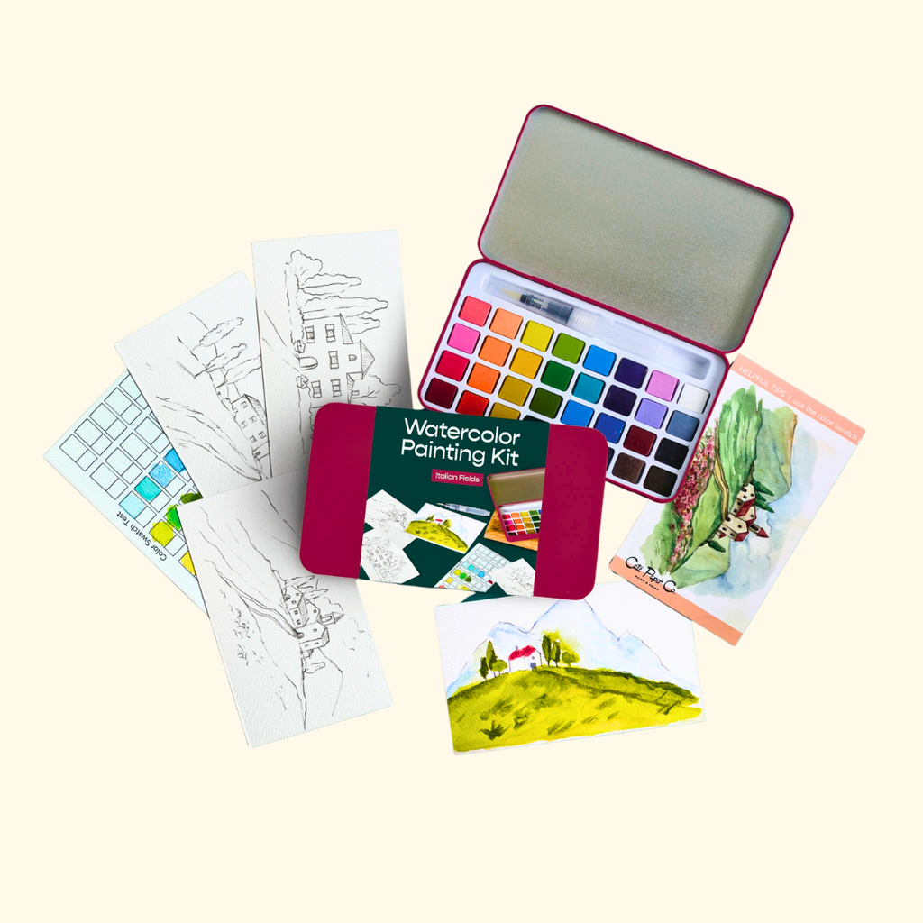 Everything included in the Italian Fields Watercolour Painting Kit by Cate Paper Co, featuring painting outlines, watercolour paints, a water brush and colour guide.