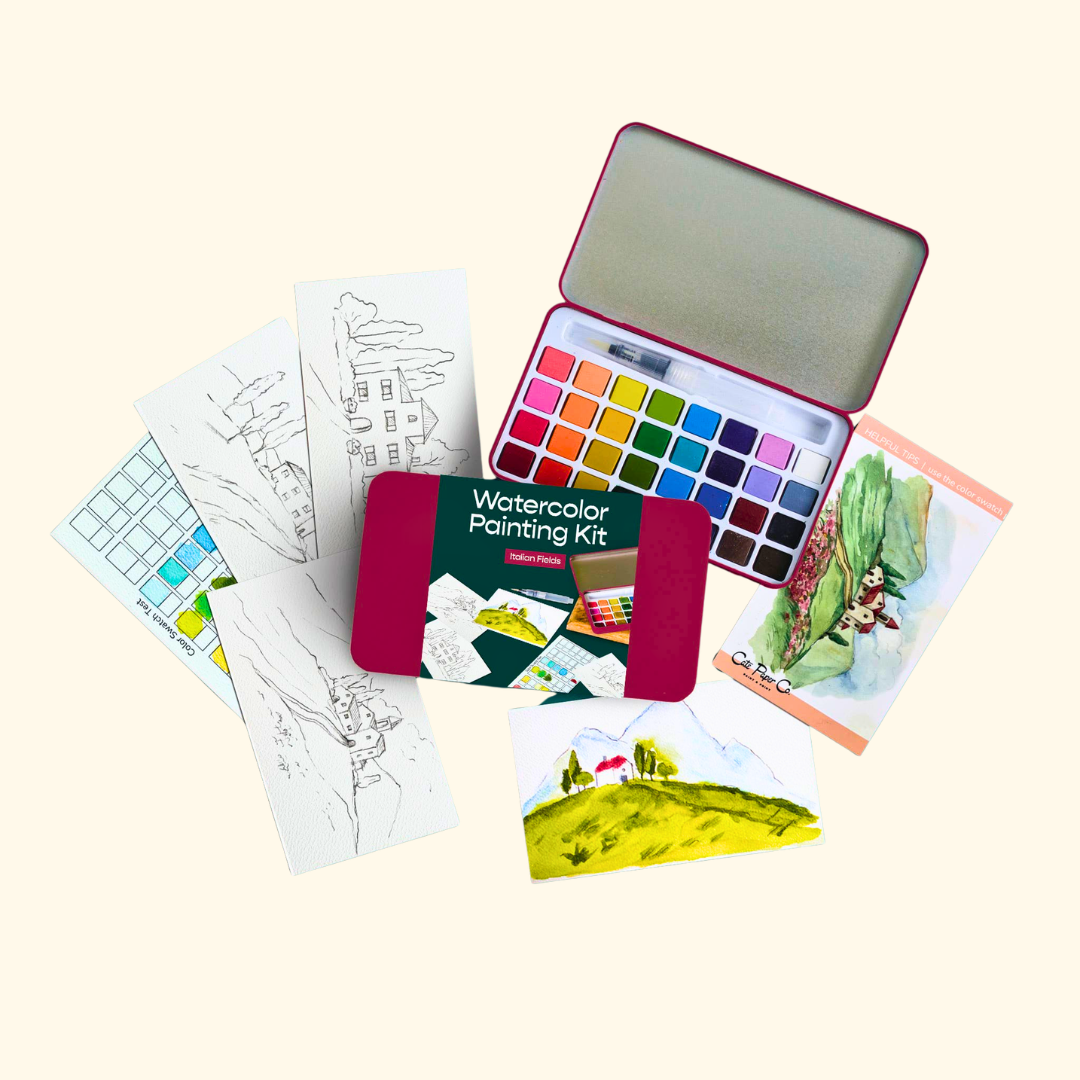 Everything included in the Italian Fields Watercolour Painting Kit by Cate Paper Co, featuring painting outlines, watercolour paints, a water brush and colour guide.