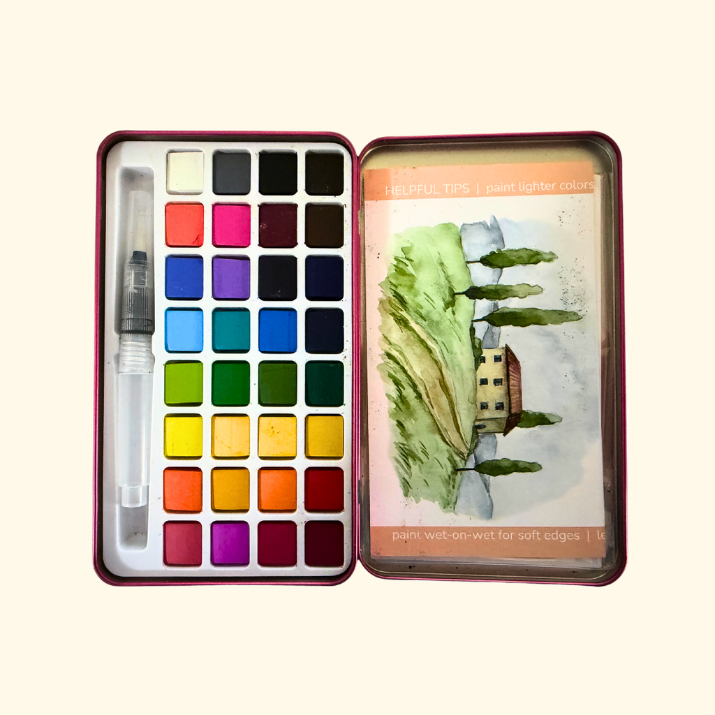 Finished Italian Fields watercolour artwork alongside the travel-sized paint palette included in the Cate Paper Co kit.