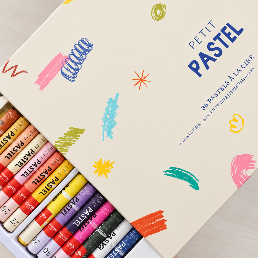 Colourful wax pastels arranged beside the Italian Summer Pastels By Numbers activity sheet by La Petite Épicerie.