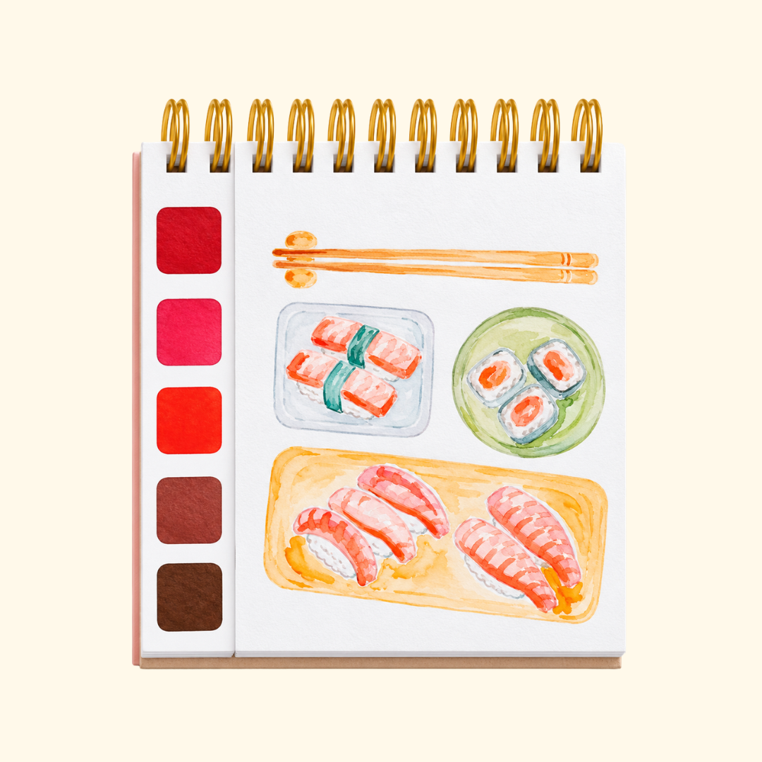 Japan Watercolour Travel Book by La Petite Epicerie showing a painted illustration of sushi, Japanese food and a watercolour palette in warm pink, orange and red tones.