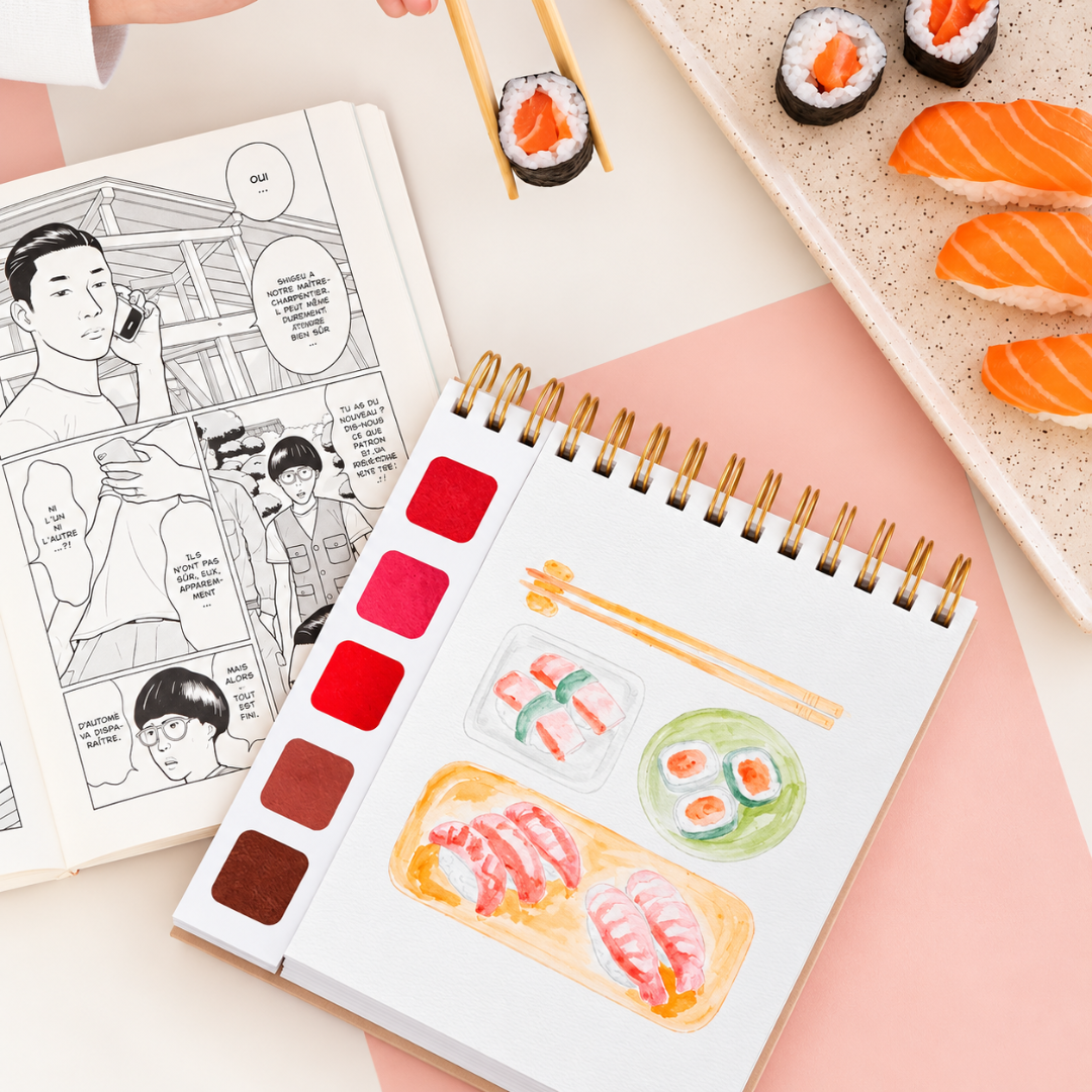 Open Japan Watercolour Travel Book by La Petite Epicerie displaying Japanese-inspired illustrations, a watercolour painting in progress and a palette of warm colours.