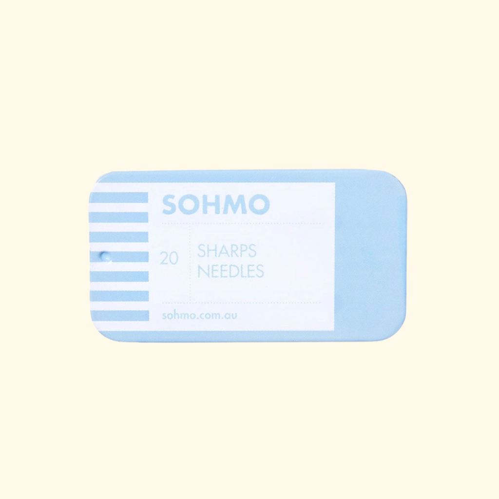 A light blue rectangular package of SOHMO Sharps Needles containing 20 needles, shown on a solid pale cream background.