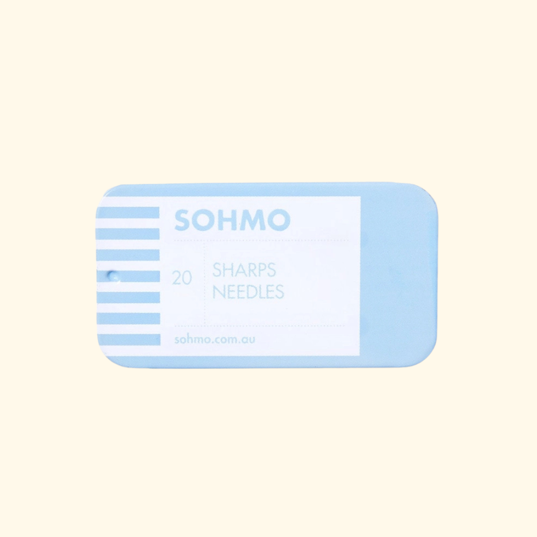 A light blue rectangular package of SOHMO Sharps Needles containing 20 needles, shown on a solid pale cream background.