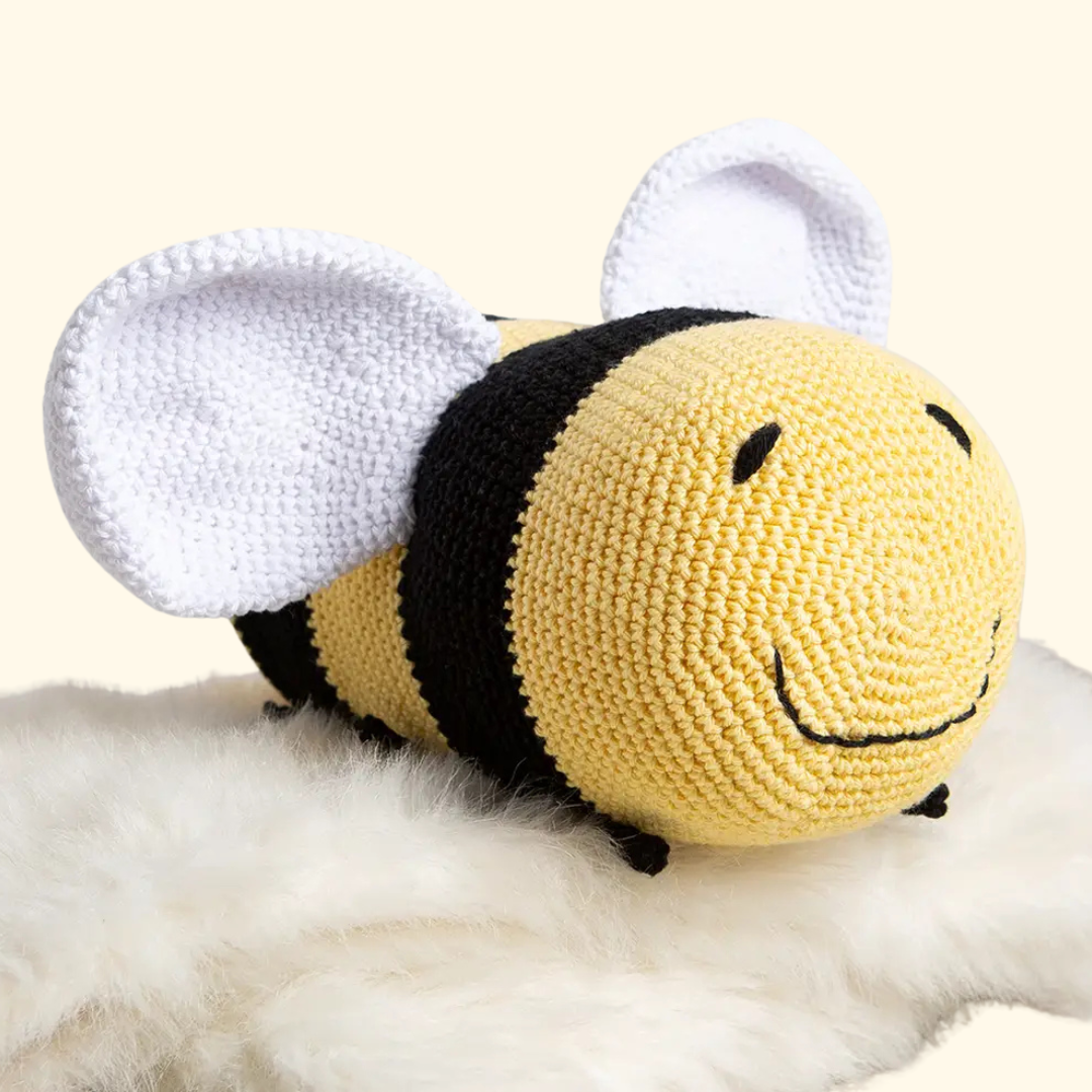 Completed Lewis the Bee crochet toy displayed on a soft surface.