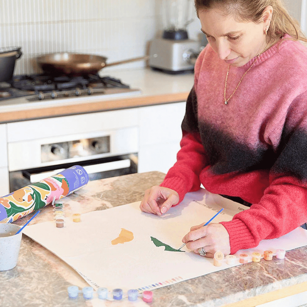 Painting the Life Is Beautiful Paint By Numbers Kit by Journey of Something on the pre-printed canvas.