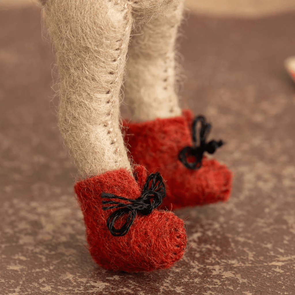 Close-up of the Little Mouse Aviator felt craft kit showing handmade red felt boots with black lace ties.