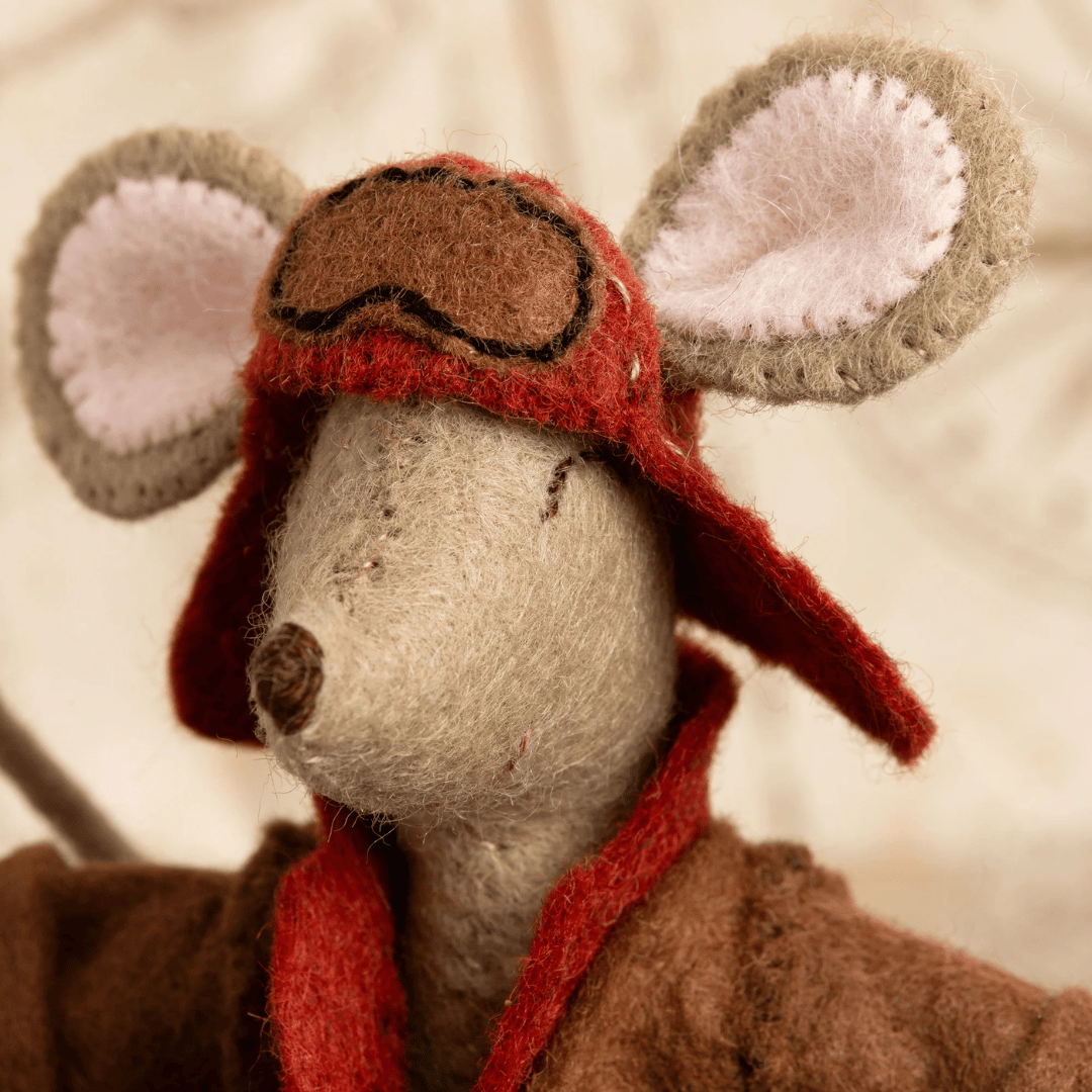 Close-up of the Little Mouse Aviator felt mouse wearing a vintage red aviator helmet with oversized felt ears.