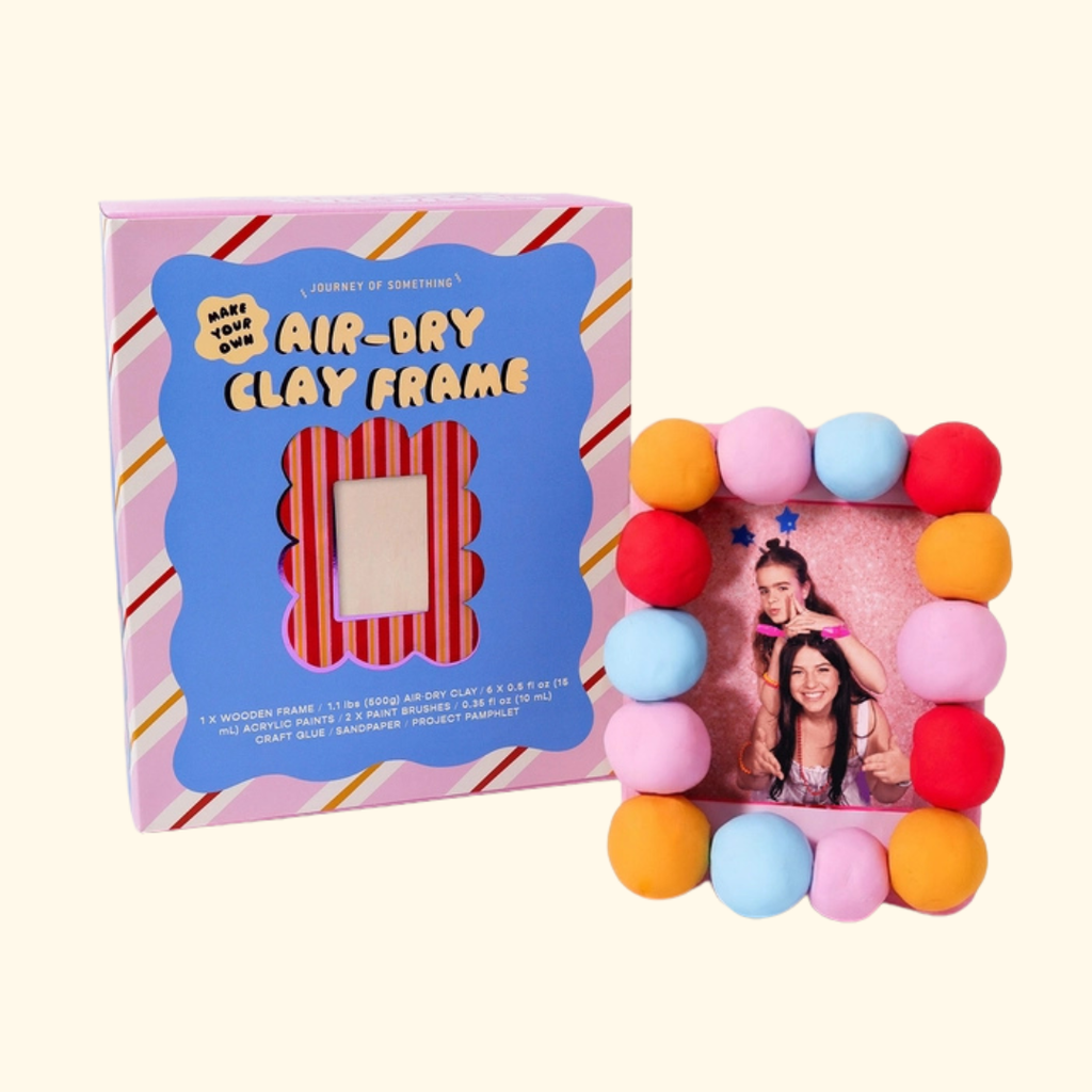 Make Your Own Air Dry Clay Frame craft kit box displayed next to the completed colourful air dry clay photo frame.