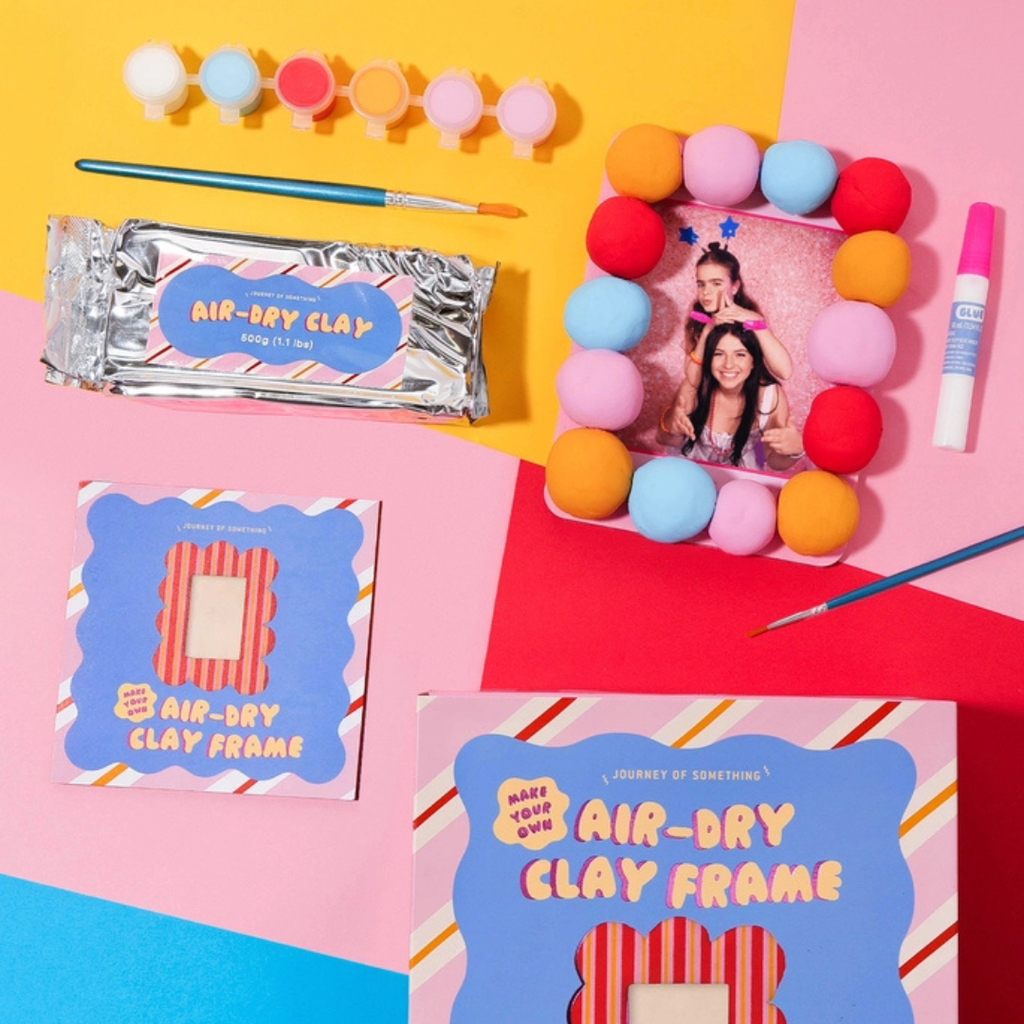 Make Your Own Air Dry Clay Frame kit by Journey Of Something displayed with air dry clay, paints, tools and partially completed frame project.