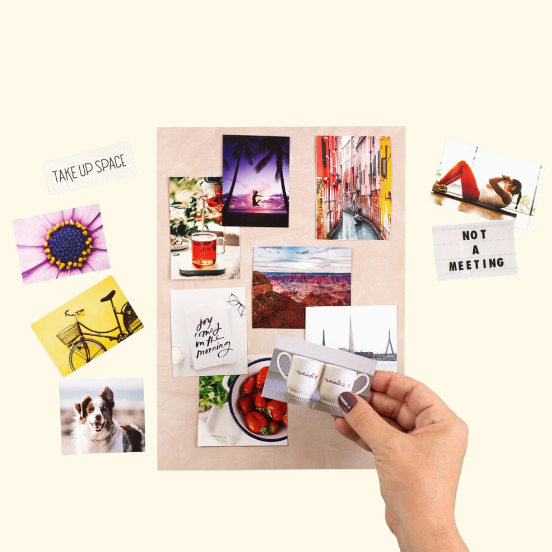 Hands arranging images from Make Your Own Vision Board Book to create a personalised vision board