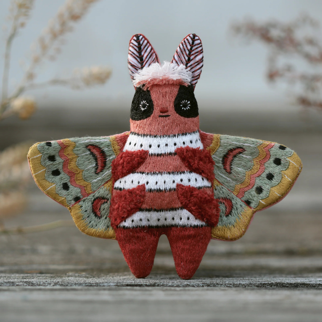 Finished moth embroidery kit displayed outdoors