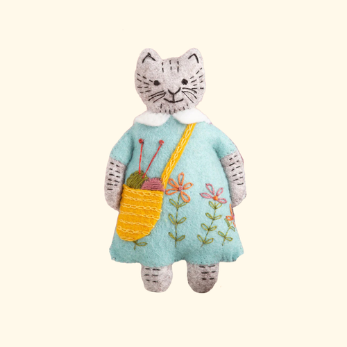 Completed Mrs Cat ornament from the Mrs Cat Felt Craft Kit by Corinne Lapierre featuring embroidered floral details and a knitted shoulder bag.