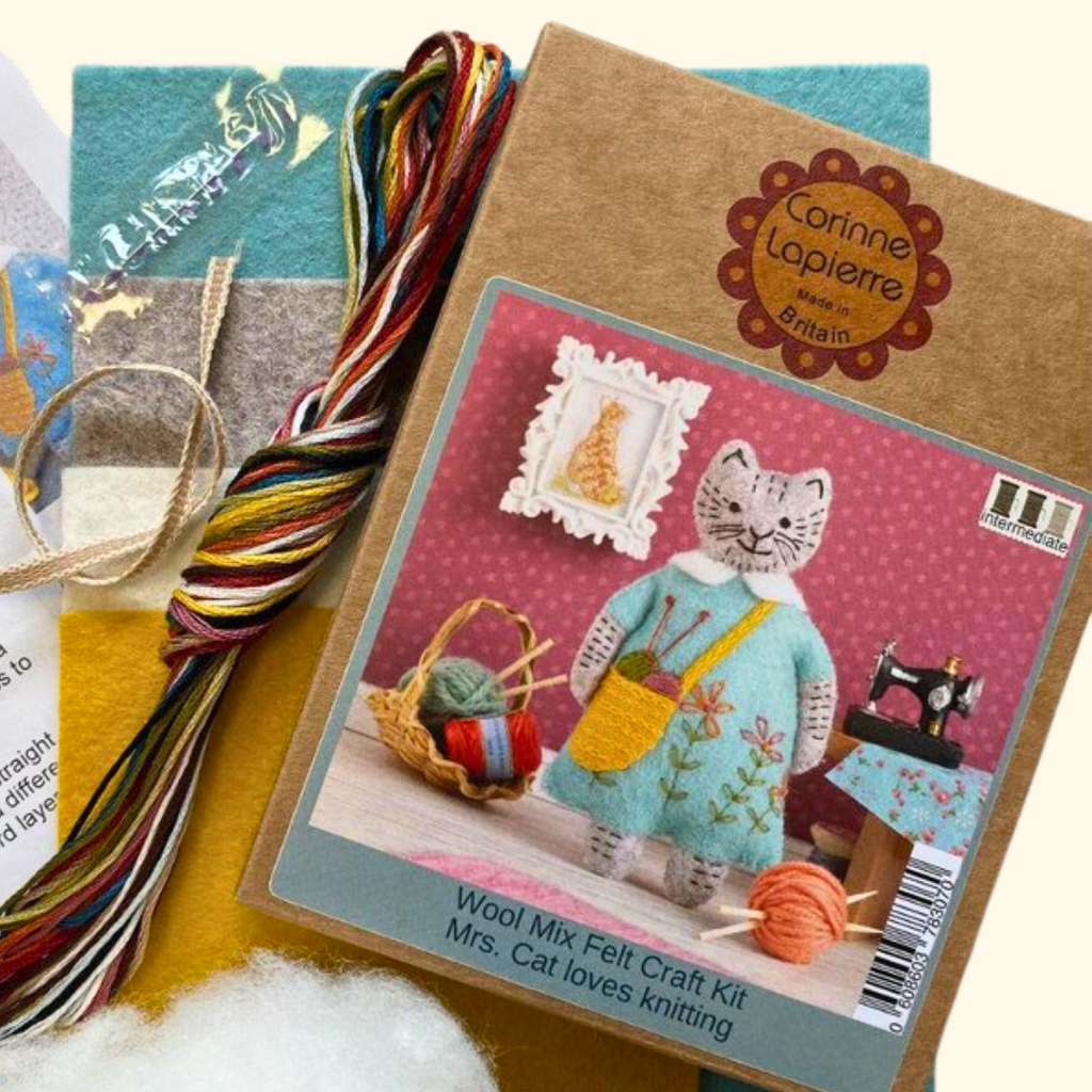 Contents of the Mrs Cat Felt Craft Kit by Corinne Lapierre including felt pieces, embroidery threads, stuffing, needle and instructions.