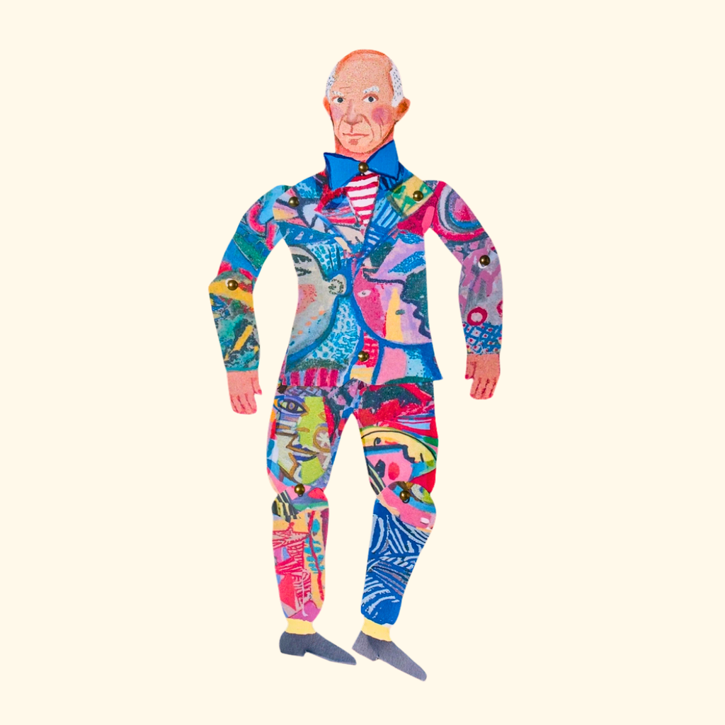 Completed Pablo Picasso articulated paper puppet wearing a vibrant abstract patterned outfit against a white background.
