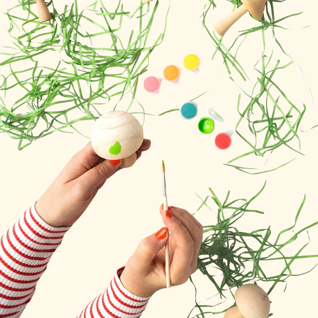 Painting a wooden mushroom using the materials included in the Paint Your Wooden Mushrooms Kit.