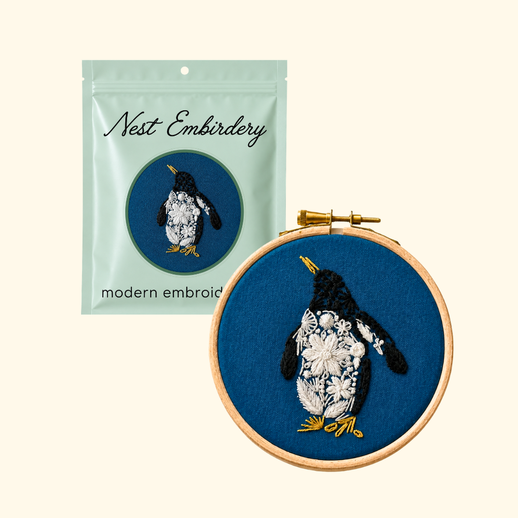 Nest Embirdery Penguin Mini Embroidery Kit packaging and completed penguin embroidery hoop.