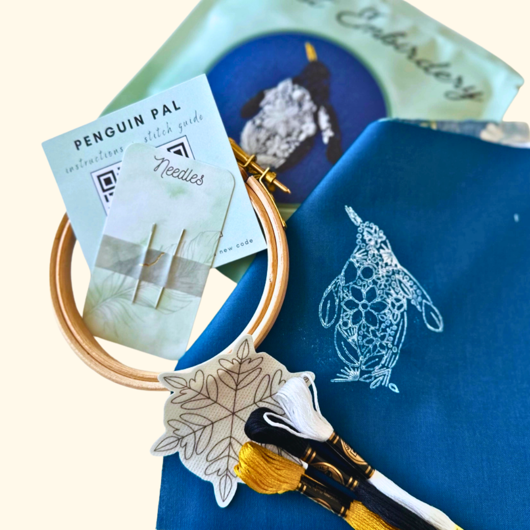 Close-up of the Nest Embirdery Penguin Mini Embroidery Kit showing textured embroidery stitches.