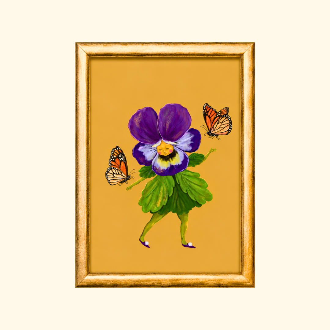 Pretty Pansy greeting card displayed in a gold frame, showcasing the whimsical pansy flower character with butterflies on a golden background.