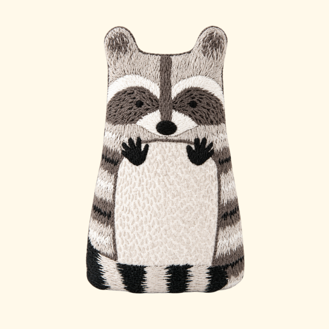 Finished Raccoon Embroidery Kit doll in black, grey and cream by Kiriki Press.