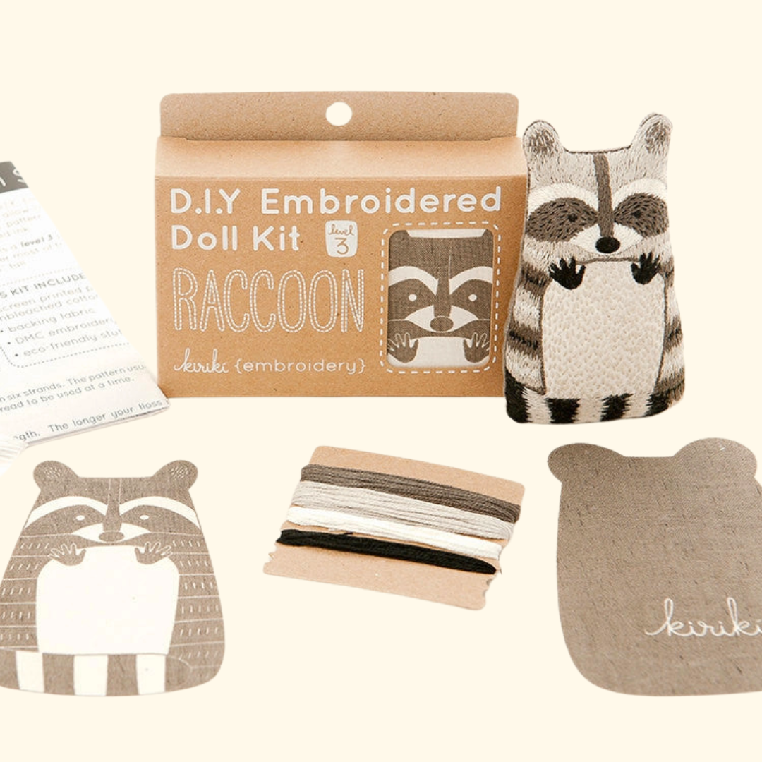 Raccoon Embroidery Kit contents including printed fabric, embroidery floss, hoop and instructions.