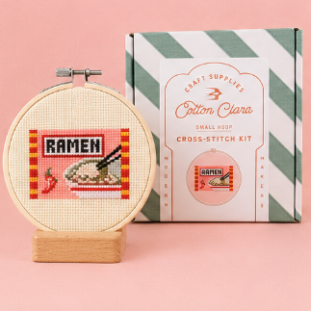 Cotton Clara Ramen Cross Stitch Kit displayed with the finished cross stitch and gift box.
