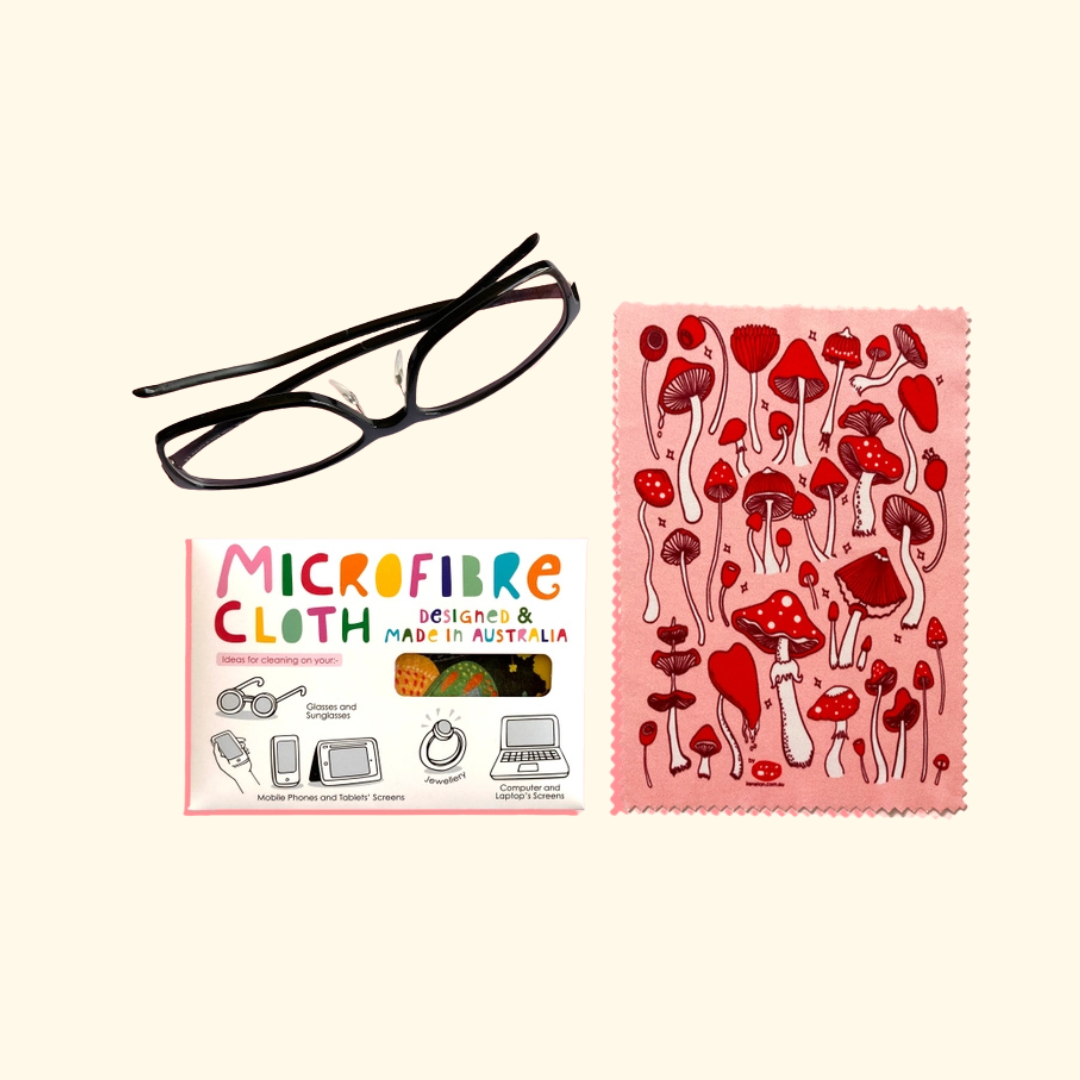Red Mushroom microfibre cloth by Missy Minzy shown folded beside its colourful product packaging.