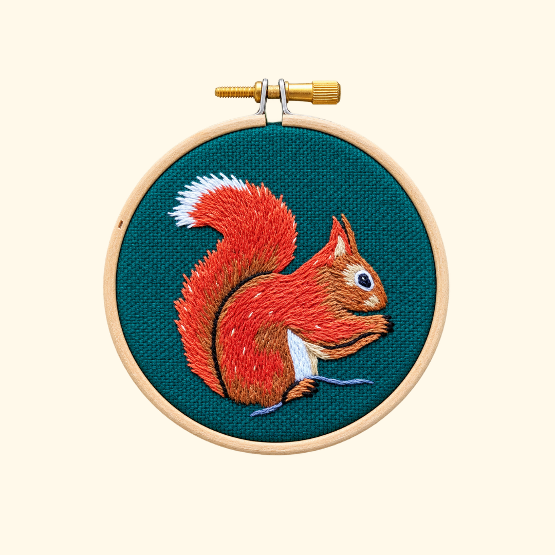 Finished Red Squirrel Mini Embroidery Kit by Paraffle displayed in a wooden embroidery hoop.