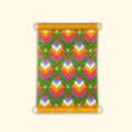 Completed Retro Blooms bargello wall hanging featuring colourful geometric floral patterns in pink, orange, green and lavender