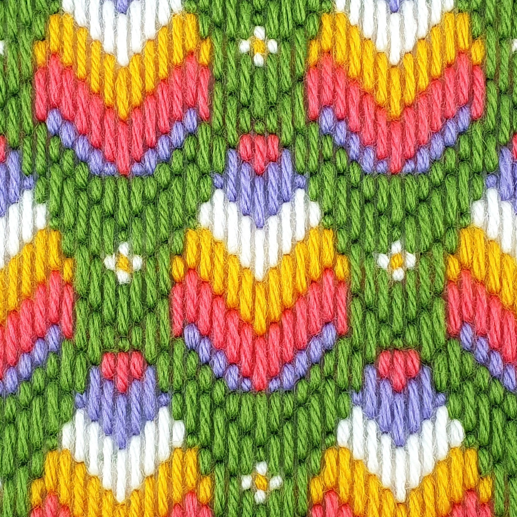 Close up of the Retro Blooms bargello pattern showing colourful geometric floral motifs and needlepoint stitching