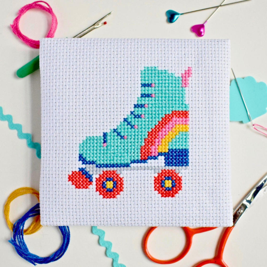 Roller Derby Mini Cross Stitch Kit in progress stitched on white Aida fabric.