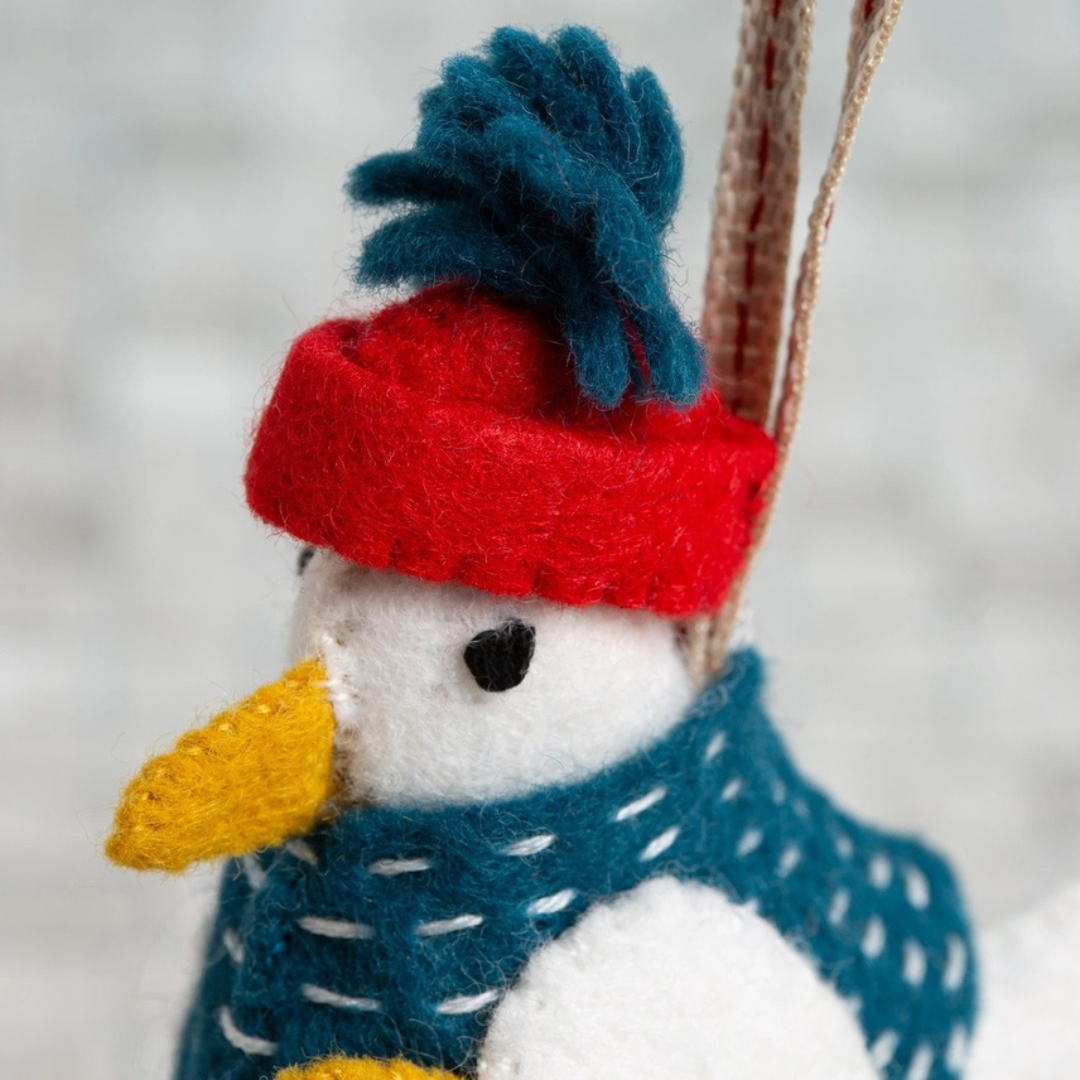 Close-up of Sam the Seagull felt craft kit highlighting the embroidered face, beanie and scarf details.