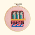 Completed sardines cross stitch design stitched in a bamboo embroidery hoop by Cotton Clara.