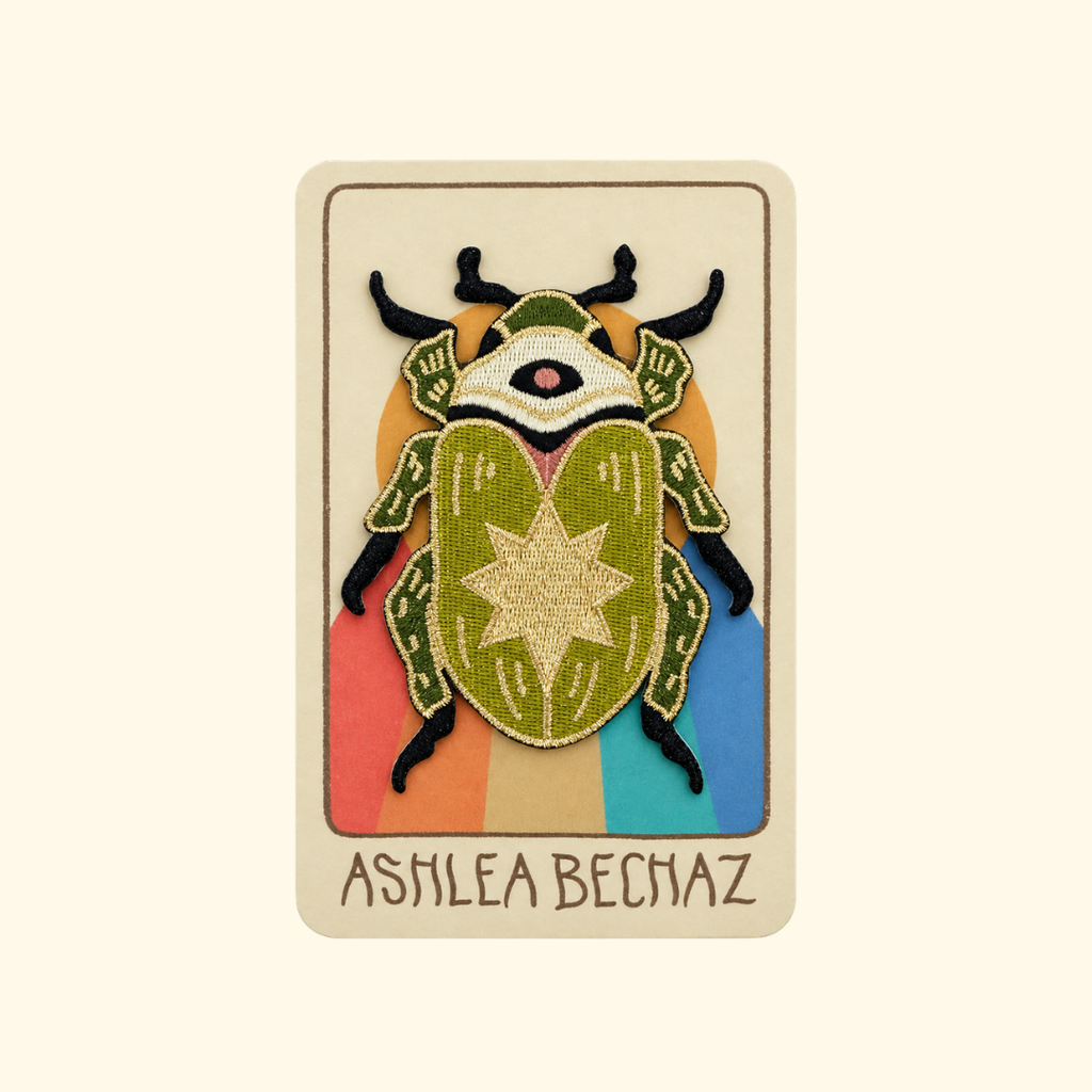 Scarab Embroidered Iron On Patch by Ashlea Bechaz Illustration displayed on illustrated backing card with a cream background.