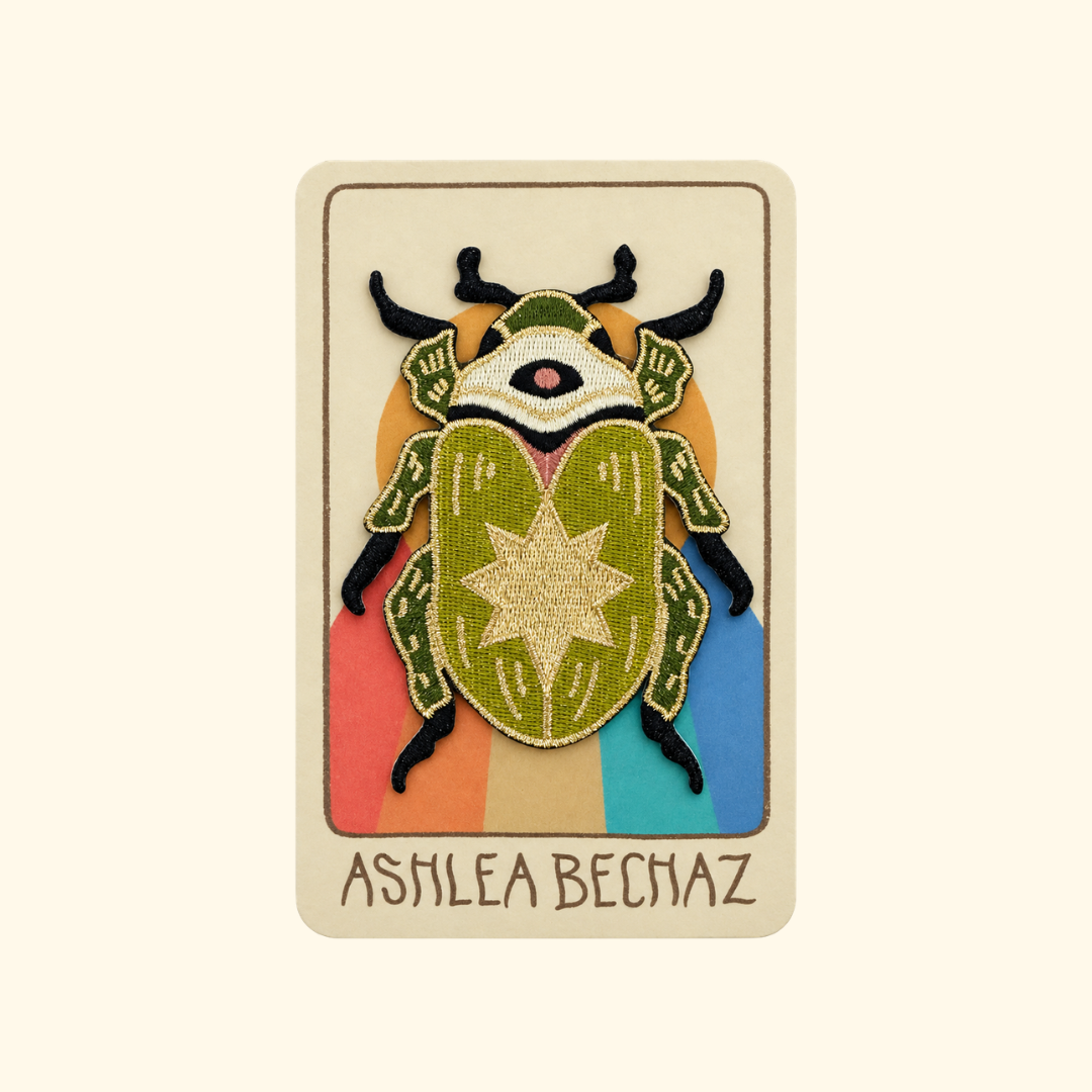 Scarab Embroidered Iron On Patch by Ashlea Bechaz Illustration displayed on illustrated backing card with a cream background.
