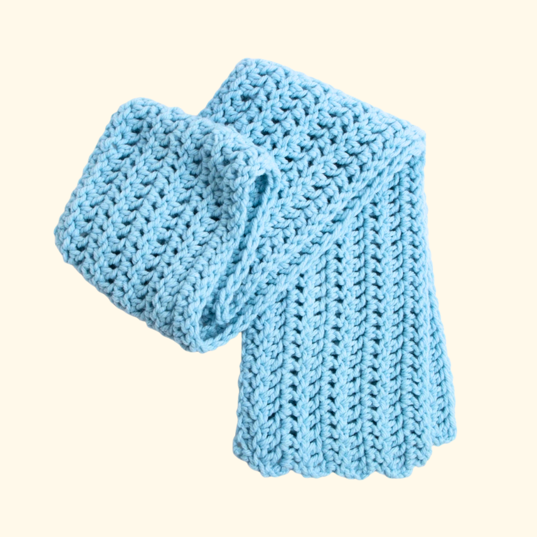 Folded crocheted scarf showing the textured stitch pattern and soft finish.