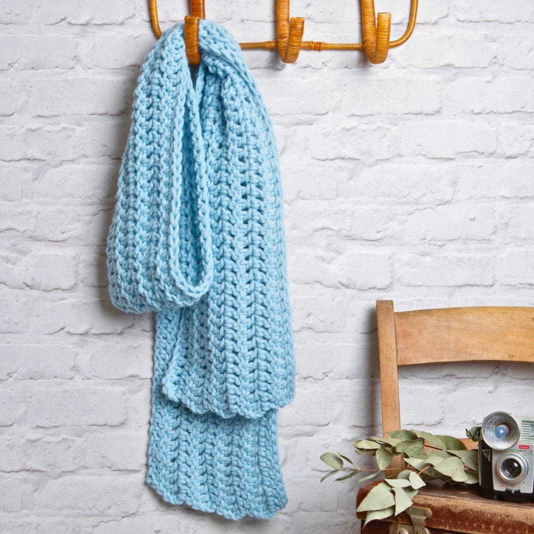 Completed crocheted scarf displayed as a cosy handmade winter accessory.