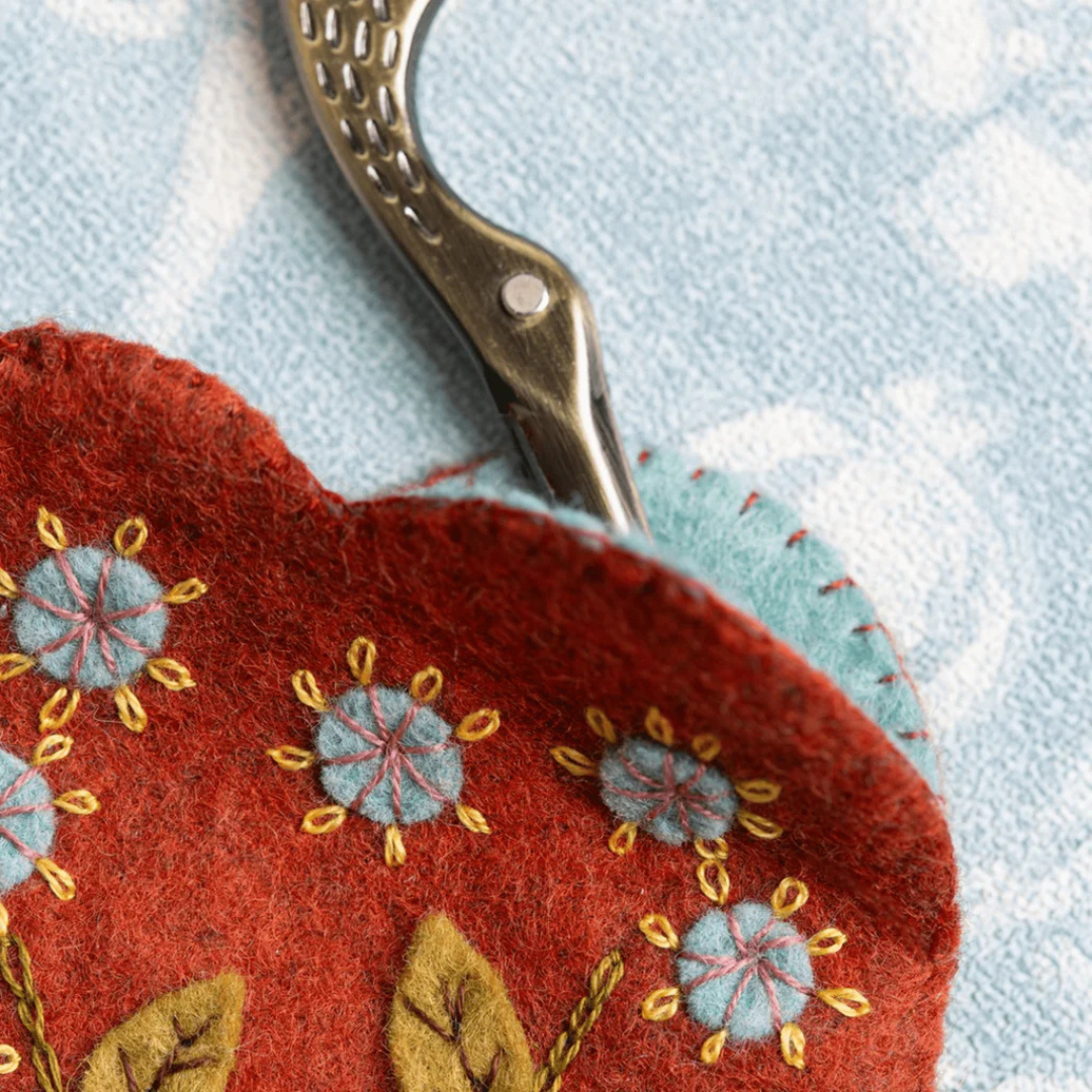 Close up of embroidered floral detail on the felt scissors pouch with decorative stitching