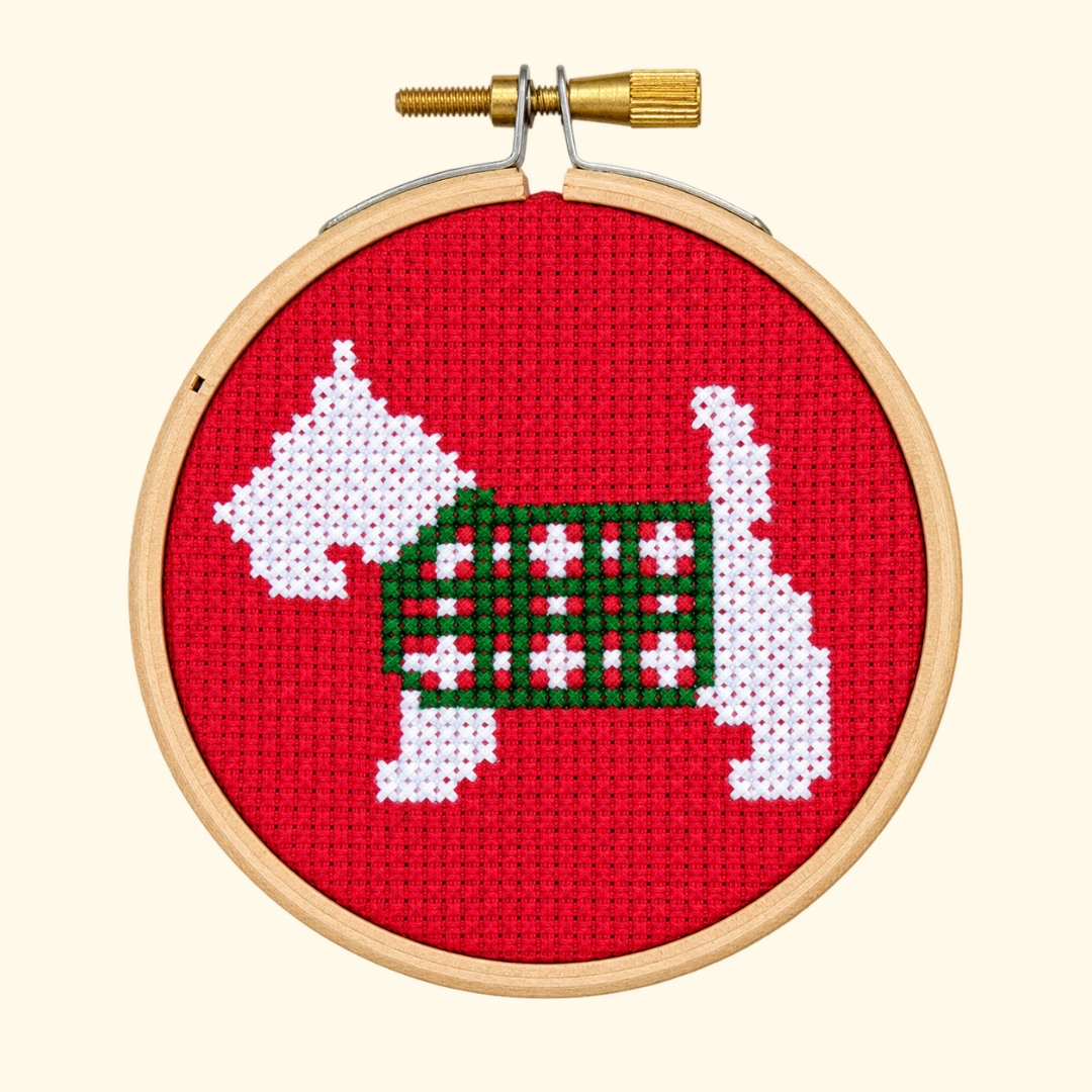 Finished Scottie Dog Mini Cross Stitch Kit by Paraffle featuring a white Scottish terrier in a tartan coat on a red background.