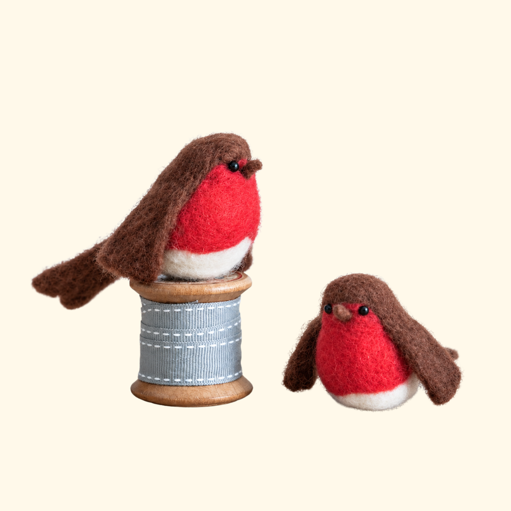 Two handmade wool robins with red breasts, brown wings and little black eyes, created using the Bergin And Bath Set Of 2 Robins Needle Felting Kit.