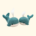 Two handmade blue wool whales with raised tails and fins, created using the Bergin And Bath Set Of 2 Whales Needle Felting Kit.