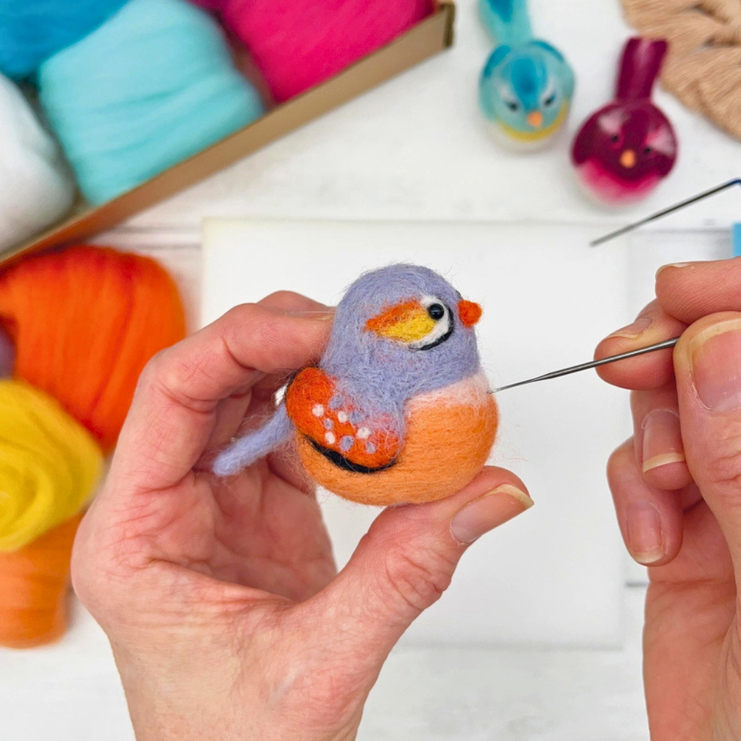 Needle felting a small orange and grey baby bird by hand